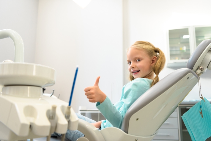 young girl sitting in dental sealants